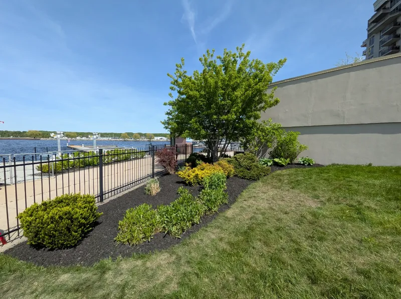 Waterfront garden bed after a spring garden bed cleanup by True North